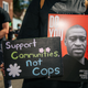 A person holds a sign of George Floyd during a demonstration on August 17, 2020 in Minneapolis, Minnesota. Community members came together for a rally to protest the city’s potential forceful reopening 38th Street and Chicago Ave, an unofficial autonomous zone known as George Floyd Square.